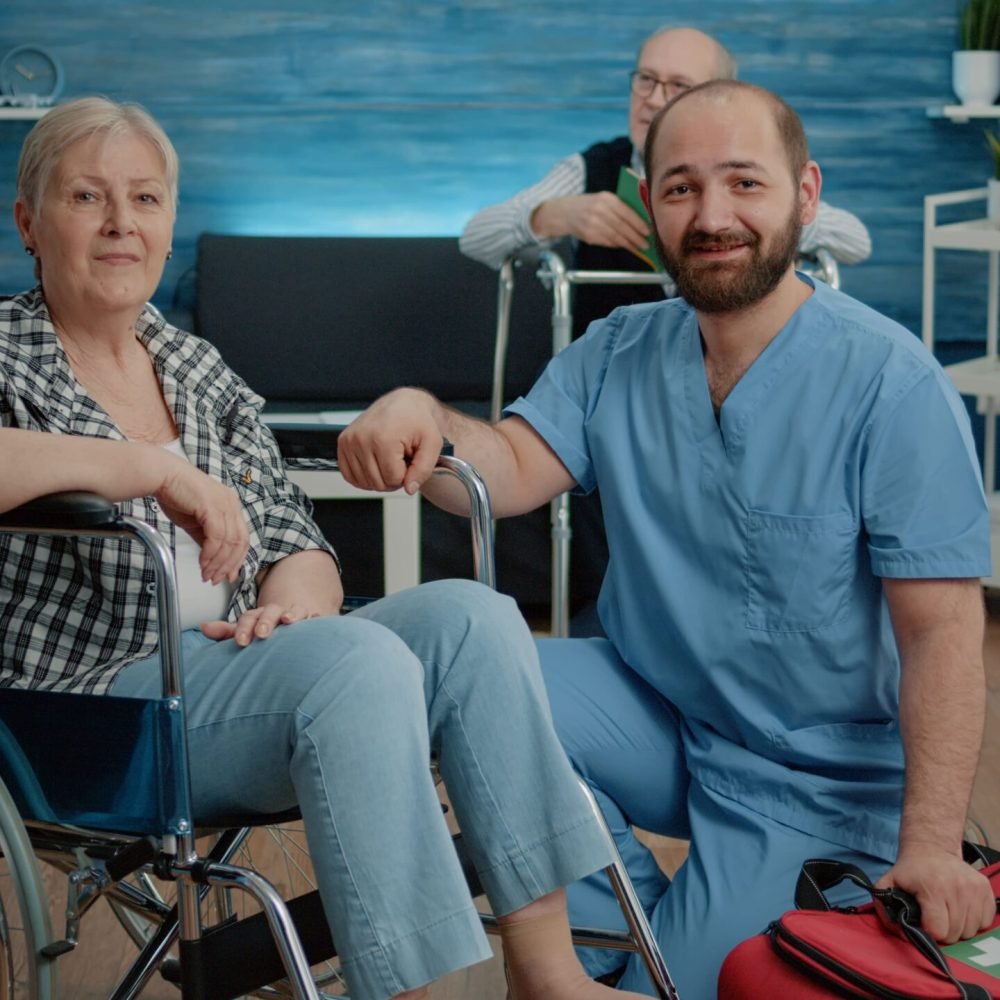 portrait-senior-woman-wheelchair-man-nurse-min